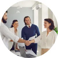Two professionals shaking hands in an office