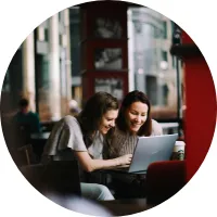 Two women founders working together at a laptop