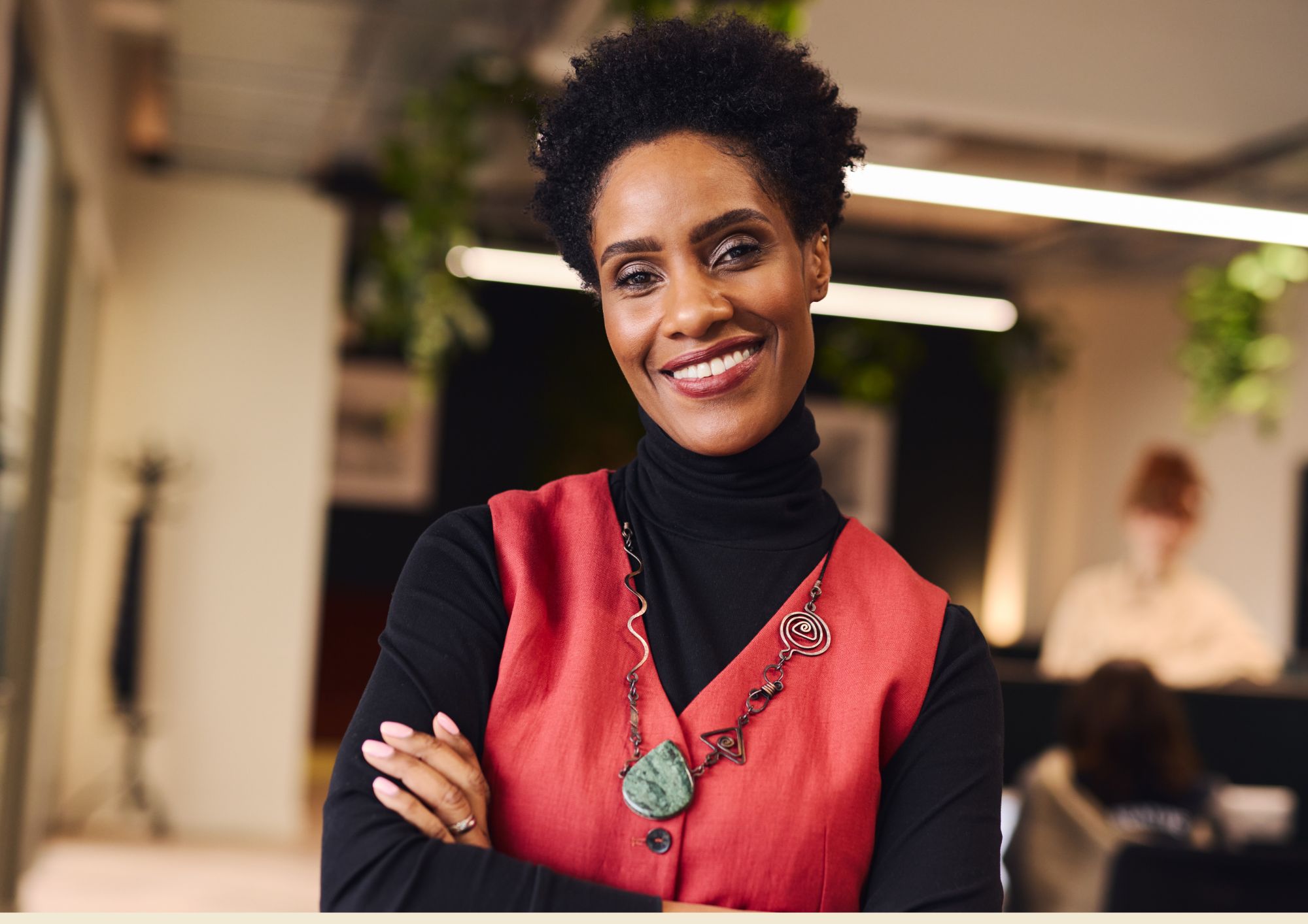 A confident woman founder smiling in her workplace