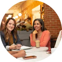 Two women reviewing a business plan over coffee
